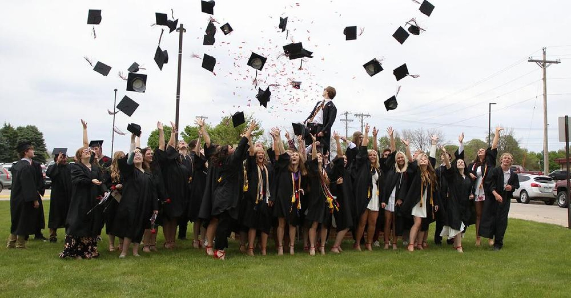 South Hardin CSD Graduates throwing their graduation caps in the air in celebration.